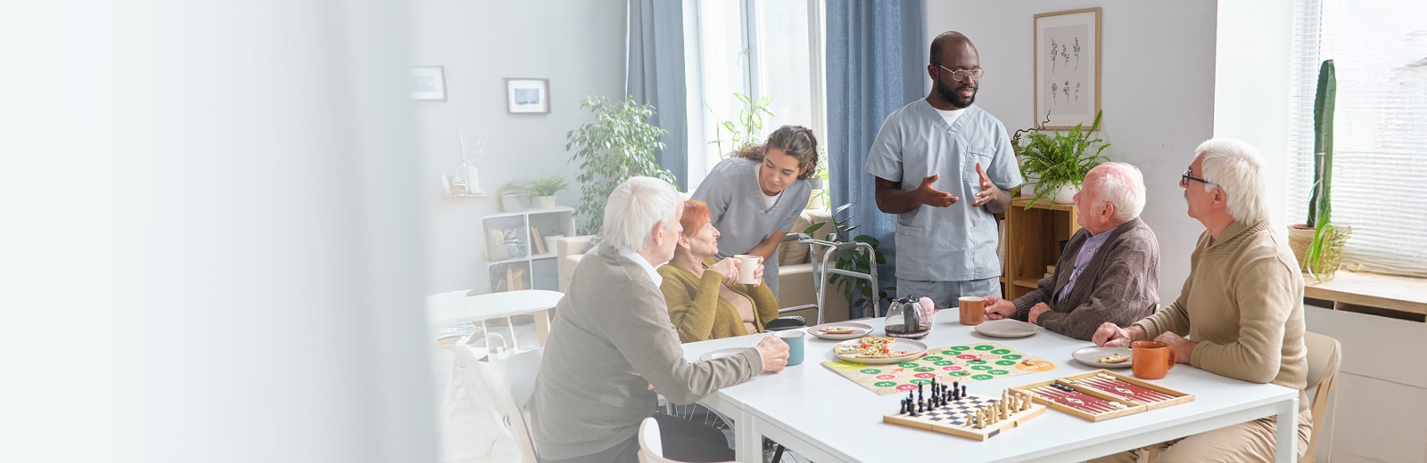 seniors sitting together at a table playing games